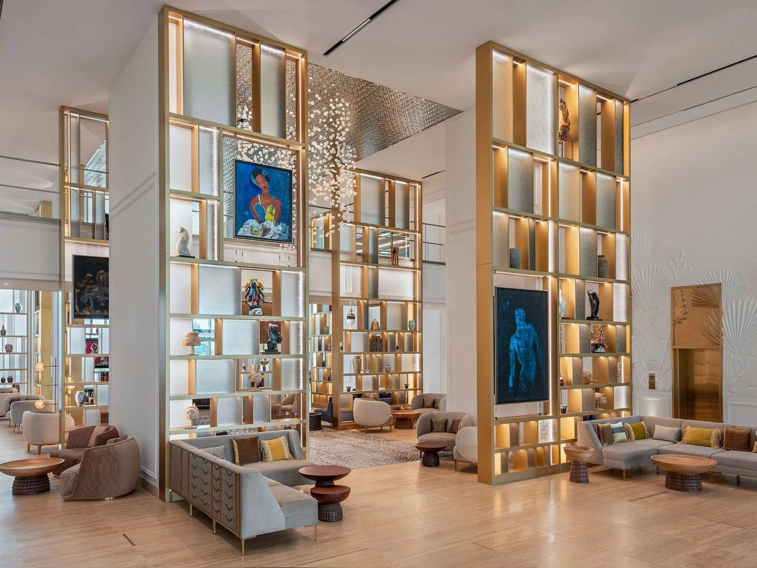 The lobby, its shelving lit and hung with Beninese art