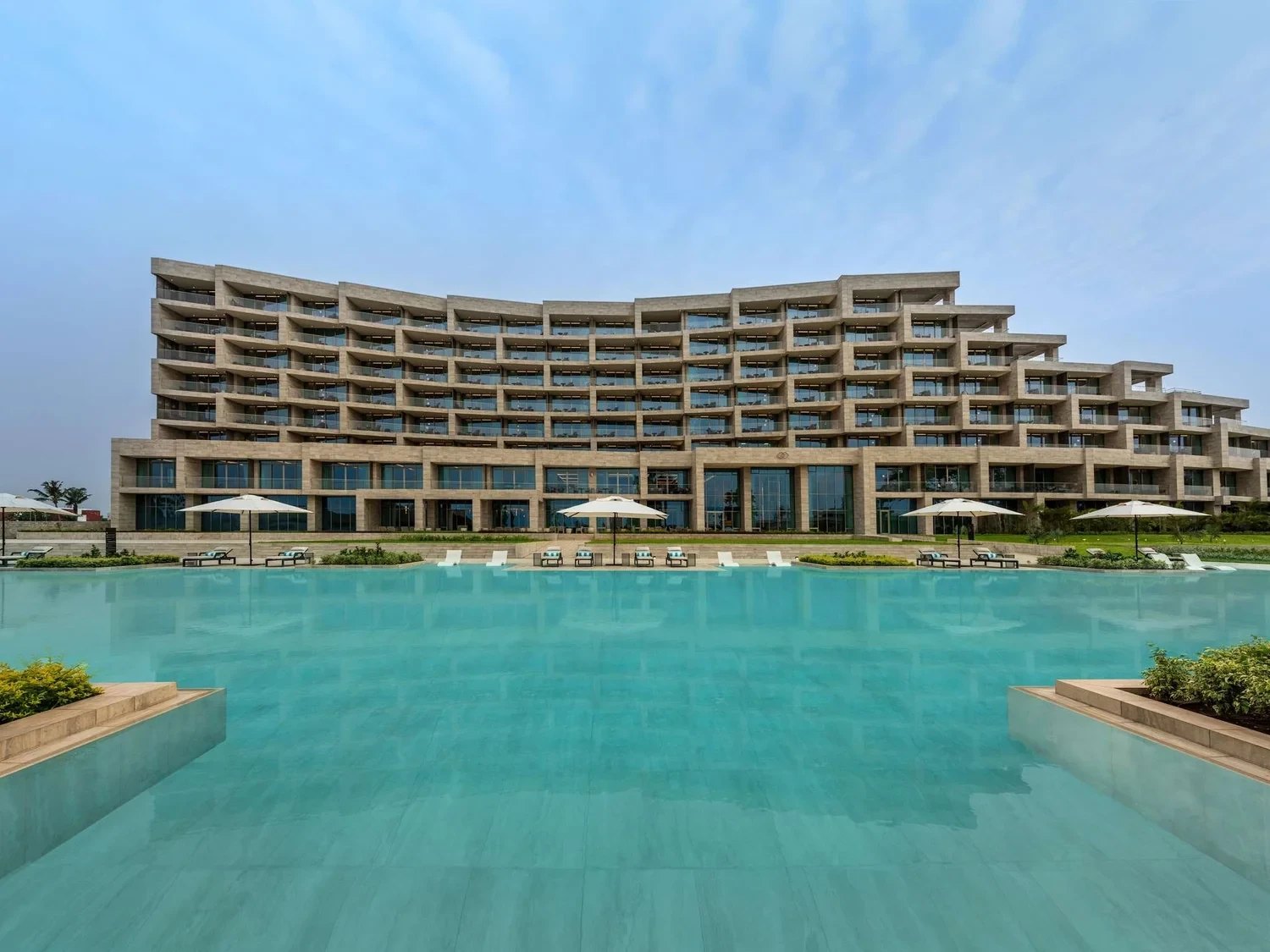 Stone terraces of the hotel above its long turquoise pool